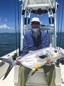 permit held by angler fishing calendar for Key West